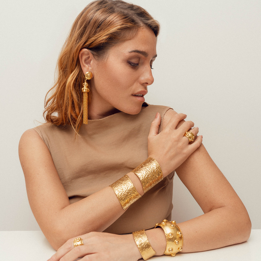 woman wearing a selection of gold jewelry from sylvia toledano and gas bijoux